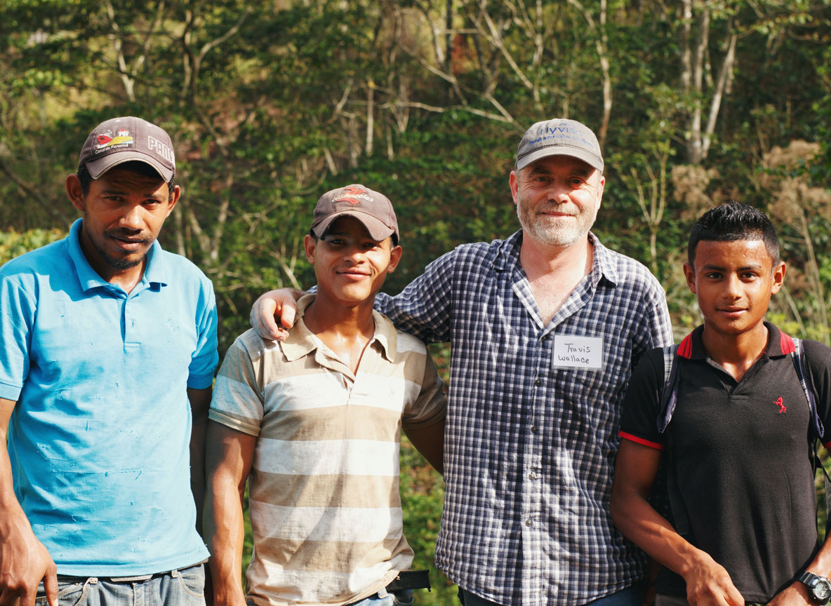 Volunteers and local compañeros lined up in front of the finished storage tank